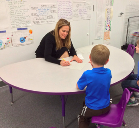 Picture of pre-k teaching working with student
