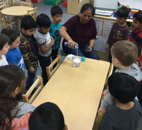 Transitional kindergarten teacher conducting an experiment.