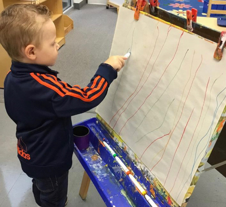 Young preschool student drawing.
